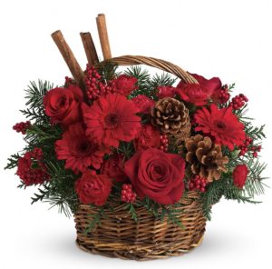 red flowers with pine cones in basket