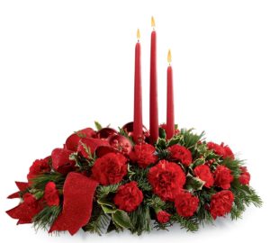 red carnations and greenery centerpiece with 3 candles