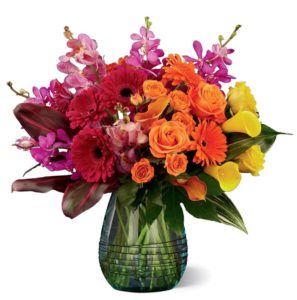 bright pink mokara orchids, folding into the deep red gerbera daisies, and then melding into the bright orange roses, and vibrant yellow calla lilies, this floral arrangement is meant to express joy with its modern design appeal.