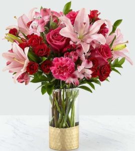  overflowing with spray roses, carnations, alstroemeria and lots of love. With a classic Valentine's color palette of pink, hot pink and red,