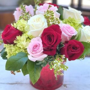 Mixed roses in a red mercury vase
